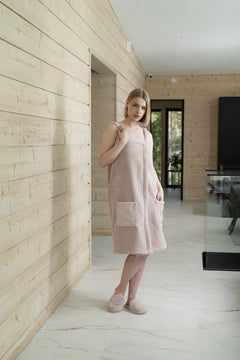 Woman wearing the dusty rose Luin spa dress